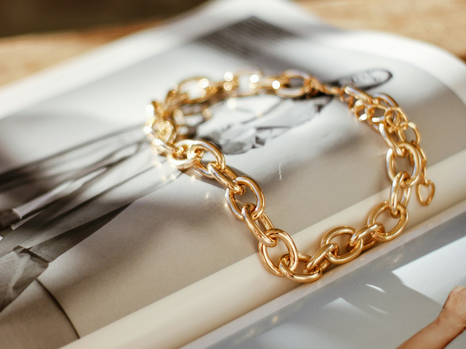 A 14K gold chain laid out on a pale surface.